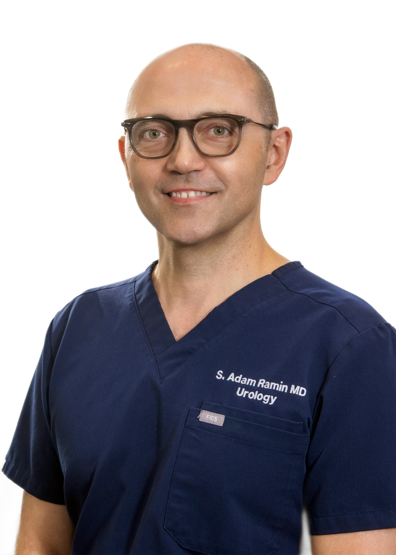 Portrait of Dr. S. Adam Ramin, MD in navy surgical scrubs